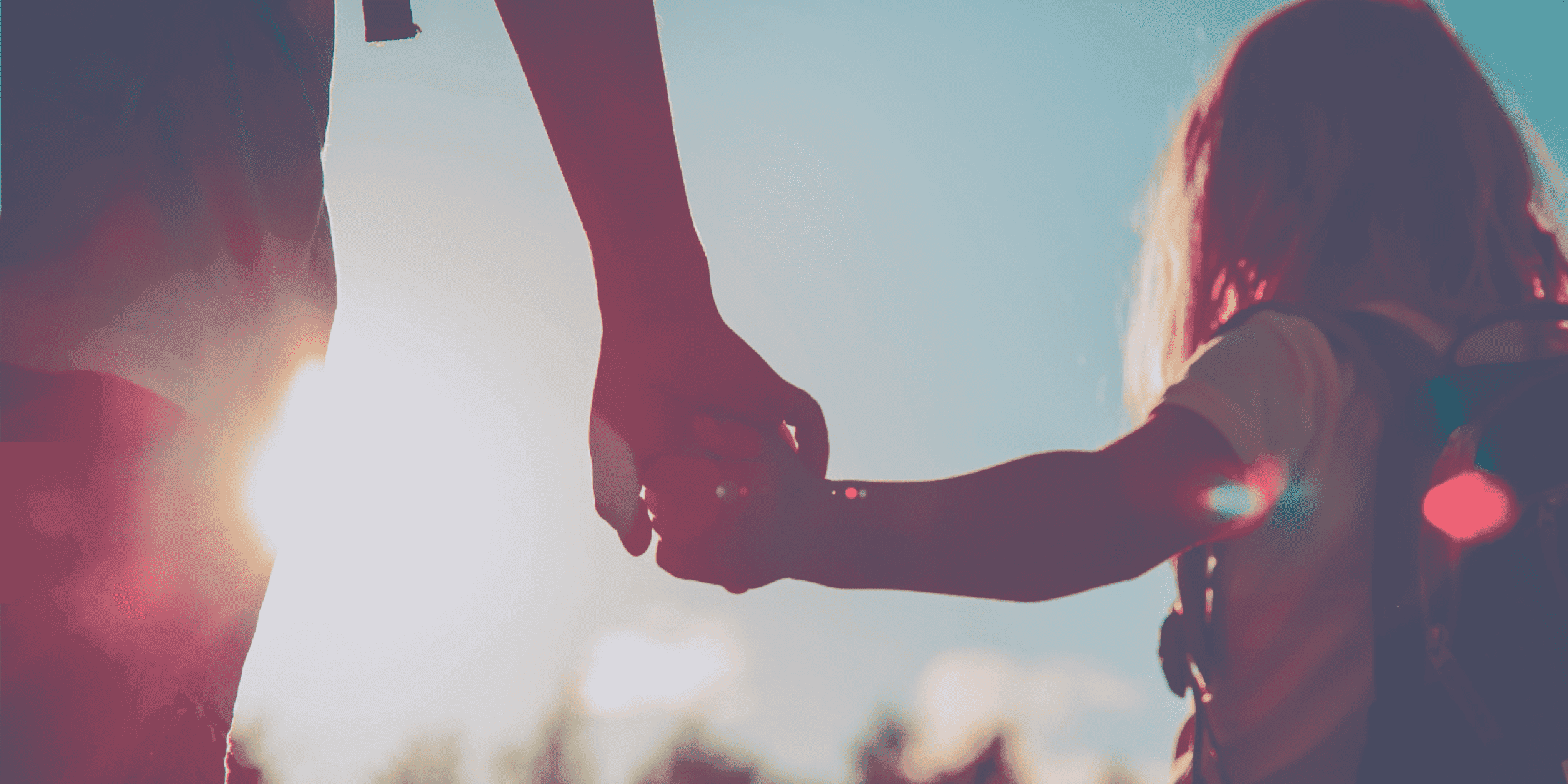 Adult holding hands with female student while walking